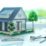 model of a house on top of construction plans