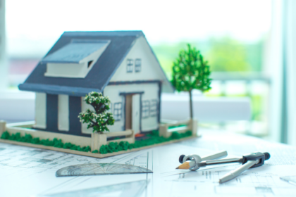 model of a house on top of construction plans